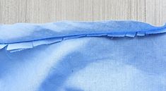 a piece of blue fabric with holes in it