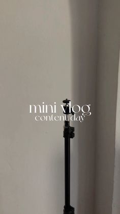 a black toilet sitting next to a white wall in a bathroom with the words mini vlog on it