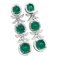 An exclusive pair of earrings in sophisticated design, so fashionable, a very adorable style, by Italian jewelry designer. Earrings come in 18K gold with 6 pieces of Natural Zambian Emeralds, spectacular color., fine quality, in perfect mixed, oval cabochon cut , of 18.80 carats, and 132 pieces of Natural Diamonds, in round brilliant cut , of 1,90 carats, F/G color VS clarity, very sparkly. Piece of high jewelry. Handcrafted by artisan goldsmith. Excellent manufacture and quality of stones. Comp Italian Jewelry Designers, Emerald Diamond Earrings, Adorable Style, 18k Gold Earrings, Zambian Emerald, Italian Jewelry, Sophisticated Design, Jewelry Designer, Zambia