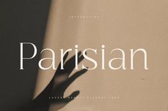 the shadow of a person's hand against a wall with the word parisian on it