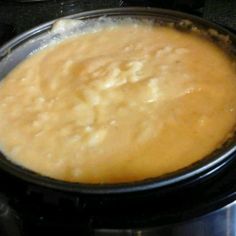 a crock pot filled with food sitting on top of a stove