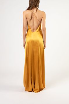 the back of a woman's dress in gold