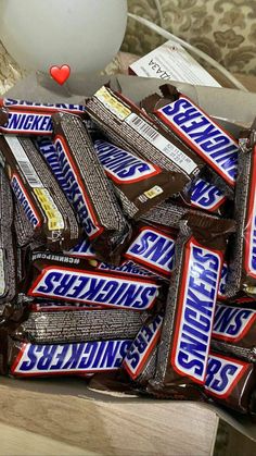 a pile of chewing bars sitting on top of a table next to a white balloon