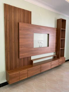 a large wooden entertainment center with built in bookshelves