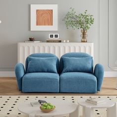 a living room with two blue couches in it