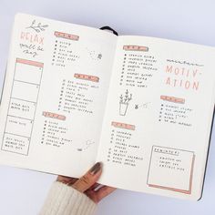 a hand holding an open planner with the words relax, motiv - action written on it