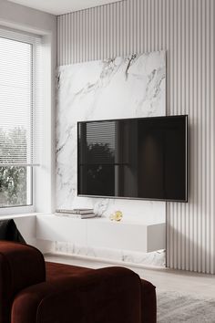 a large flat screen tv mounted to the side of a wall in a living room