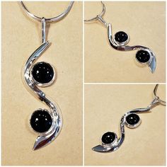 I fabricated this Sterling Silver Pendant to swirl around the two 10 mm round Black Onyx cabochon's.  The curved flowing silver gives motion to the piece.  It is 2-5/8 inches long × 3/4  inches wide. A very fun, yet elegant piece. I am including a Sterling Silver 18 inch long 8 sided Snake Chain so it can be worn immediately. Modern Round Cabochon Necklace, Modern Cabochon Necklace, Modern Cabochon Round Pendant Jewelry, Modern Cabochon Round Pendant, Modern Jewelry With Round Cabochon Pendant, Elegant Silver Cabochons For Gifts, Silver Round Cabochons With Polished Finish, Silver Round Cabochons For Formal Use, Round Silver Cabochons For Formal Use