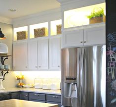 a kitchen with stainless steel appliances and wooden counter tops, along with stools in front of the island