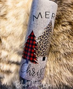 thermos bottle is decorated with a christmas tree and leopard print, which reads merry christ