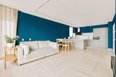 a living room filled with furniture and blue walls