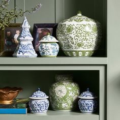 the shelves are filled with vases and other decorative items in blue and green colors