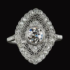 an antique style diamond ring on a black background