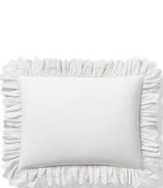 a white pillow with ruffles on the front and back of it, against a white background