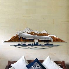 a bed sitting under a painting on top of a wall