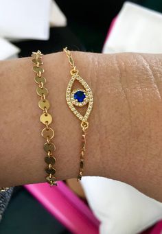 "This listing is for the evil eye only. Click the link below for the gold filled dotted bracelet. https://www.etsy.com/listing/288519563/gold-disc-coin-bracelet-14kt-gold-filled?click_key=74964c3b19e75b2a10ed5ddf0e6066d5aaae5c96%3A288519563&click_sum=8b152785&ga_search_query=dotted%2Bcoin%2Bbracelet&ref=shop_items_search_1&pro=1&frs=1&sts=1 Evil Eye Bracelet Protection Bracelet I love this beautiful Evil Eye charm bracelet, perfect for layering and elegant enough to stand on it's own. Perfect for daytime wear and also glamorous for all night occasions.  ♥ Evil Eye is an amulet that is popular in Middle East and North Africa. It's believed to protect the wearer from harm's way and bring good energy to the wearer. ♥  The \"evil eye\" talismans have been used for centuries to protect against Gold Round Evil Eye Bracelet Dainty Style, Gold Round Dainty Evil Eye Bracelet, Dainty Gold Round Evil Eye Bracelet, Evil Eye Bracelet Silver, Evil Eye Bracelet Gold, Gold Evil Eye Bracelet, Bracelet Evil Eye, Hamsa Bracelet, Coin Bracelet