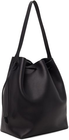 Polished saddle calfskin tote in black. · Fixed shoulder strap · Gold-tone logo stamp at side · Drawstring closure · Zip and patch pocket at interior · H14.5 x W12 x D7 Supplier color: Black Luxury Black Bucket Bag For Business, Luxury Black Business Bucket Bag, Black Calf Leather Bucket Bag For Daily Use, Black Calf Leather Top Handle Bucket Bag, Black Calf Leather Bucket Tote Bag, Black Calf Leather Bucket Bag With Adjustable Strap, Black Calf Leather Bag With Dust Bag Included, Black Calf Leather Shoulder Bag, Black Calf Leather Bag For Work