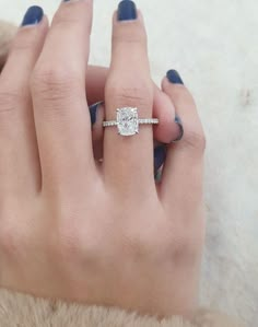 a woman's hand with a diamond ring on it