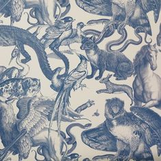 a blue and white wallpaper with many different types of animals on it's surface