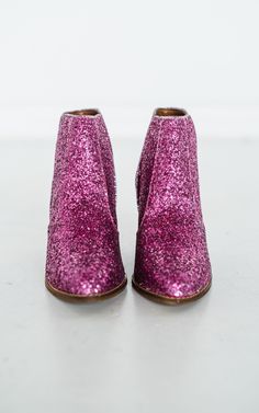 Some of our best selling booties last year were the charcoal version of these. They are back in fuschia! NOTHING quite says 'I'm here for the party' like a pair of glitter booties. Rubber heel and sole. 3 inch heel Fit true to size, if you are in between sizes, go with your larger size. If your foot is wide at all, also size up. Waterproof Jewelry, 3 Inch Heels, Denim Leggings, Rubber Heels, Pink Glitter, Back To Black, Outerwear Women, Watch Bands, Bootie Boots