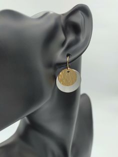 Add two or more items to your cart and enter the code: MOREMETAL during checkout for 15% off of your whole order! These incredibly elegant handmade disc earrings are made from .999 fine silver and 14k gold filled metal. 14k gold filled means that 5% of the metal used in making each gold piece is made from 14k gold which has been bonded with a base metal. This gives the wearer the advantages of wearing 14k gold without the cost. The fine silver has a brushed finish which contrasts nicely with the hammered texture of the gold from each pair of earrings. The silver disc of each earring measures at 7/8 inches in size, or nearly a full inch in diameter. The smaller gold disc measures 5/8 inches in diameter. Finishing off each of these earrings is a 14k gold filled ear wire along with a hypoalle Modern Round Earrings For Gifts, Elegant Metal Round Disc Earrings, Hammered Round Disc Earrings As Gift, Hammered Round Disc Earrings For Gift, Modern Round Pendant Earrings As Gift, Modern Nickel-free Round Disc Earrings, Elegant Nickel Free Round Disc Earrings, Nickel-free Metal Round Disc Earrings, Elegant Silver Disc Earrings