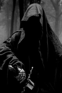 a person wearing a black hooded jacket and holding a knife