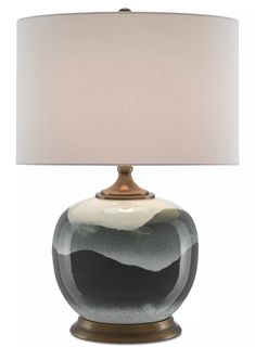 a black and white lamp with a beige shade on the top is sitting in front of a white background