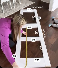 a woman is measuring the height of a table with a tape measure line on it