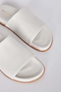 Minimal and effortless we love pippy for all the ease of an ultra-padded slip-on. luxe vegan leathers and comfy footbeds make this iconic slide new again. Synthetic Flat Slides With Leather Footbed, Chic Synthetic Slides With Leather Footbed, Flat Slides With Leather Footbed, White Leather Slides With Textured Sole, Modern Everyday Slip-on Slides, Synthetic Slides With Leather Footbed, Comfortable White Slides With Leather Footbed, Modern Slip-on Slides With Leather Footbed, Modern Leather Footbed Slip-on Slides