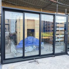 an image of a building being built with glass doors and windows in the process of being installed