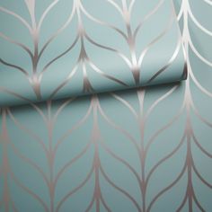 a blue wallpaper with silver leaves on it