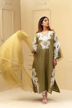 Elevate your style with our Olive Green Shalwar Kameez. Made with luxurious organza and silk lining, this stunning ensemble features intricate resham work and hand embroidery and cutwork on the neck and body. The dupatta also boasts cutwork detailing, adding a touch of elegance. Step out in confidence and sophistication with this must-have piece. 3-Piece Suit Elegant Sharara With Dabka Work In Mulmul, Elegant Lawn Suit With Chikankari Embroidery In Shantoon, Elegant Sharara With Dabka Work, Elegant Shantoon Lawn Suit With Chikankari Embroidery, Elegant Lawn Suit With Chikankari Embroidery, Elegant Churidar With Chikankari Embroidery In Shantoon, Elegant Shantoon Kurta With Chikankari Embroidery, Elegant Chikankari Embroidery Churidar In Shantoon, Elegant Sets With Chikankari Embroidery In Shantoon