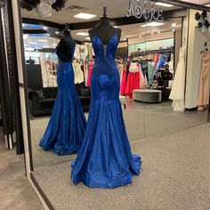 This Dress Features A Beautiful Metallic Fabric, Flattering Fit & Flare Figure, Low V-Neckline And Strappy Open Back, And Back Zipper Closure. Fitted Blue V-neck Dress For A Night Out, Fitted Blue V-neck Prom Dress, Blue Fitted V-neck Prom Dress, Blue Fitted V-neck Dress For Prom, Red Floor Length Dress, Tulle Dress Short, Formal Long Dress, Prom Dress Burgundy, May Queen