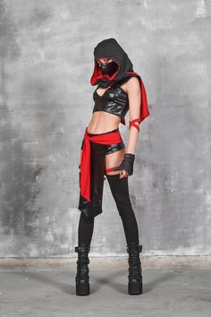 a woman dressed in black and red is posing for the camera with her hands on her hips