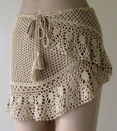 a crocheted skirt with tassels on it