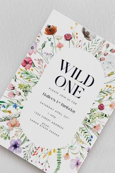 the wild one birthday party card is shown with flowers and leaves on it, in white paper