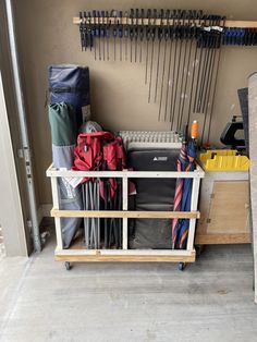 there are many bags and skis on the rack in front of the garage door