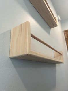 two wooden shelves mounted to the side of a wall