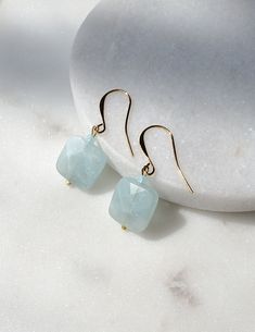 Solazur earrings "Cara--- Different. Comfortable. Good energy. ♧ Aquamarine has been used as a symbol for youth and happiness due to its color. Beautiful and lightweight pair of earrings with a modest spark. Make them yours or offer them as a gift, they will be well received : -) ☆ March Birthstone Earrings are made with genuine Aquamarine square stone beads. On gold plated hooks. Hypoallergenic.  Due to natural stone inclusions, each pair will be a one of a kind jewelry piece.  Stone story: Aqu Gold Aquamarine Gemstone Earrings, Aquamarine Gemstone Earrings For Anniversary, Handmade Gold Aquamarine Earrings, Blue Drop Earrings As Gift For Her, Handmade Aquamarine Dangle Earrings, Adjustable Aquamarine Jewelry As Gift, Handmade Aquamarine Drop Earrings, Aquamarine Dangle Earrings With Ear Wire, Gold Aquamarine Drop Earrings