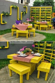 this is an image of a yellow table and bench in the yard with flowers on it