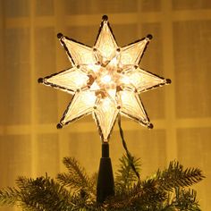 a lighted christmas tree topper with a star on it