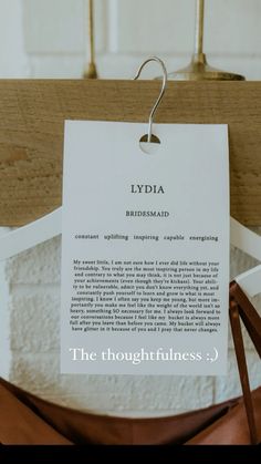 there is a piece of paper hanging from a clothes hanger with the words lydda on it