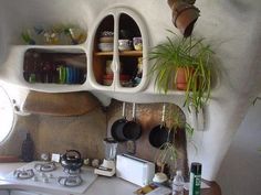 a small kitchen with pots and pans on the stove