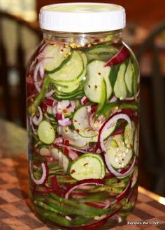 a jar filled with sliced up vegetables on top of a table