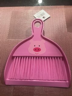 a pink brush with a pig face on it