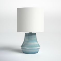 a blue lamp with a white shade on it