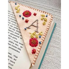 Brand: AYILISColor: FallFeatures: 🔖【VERSATILE APPLICATION:】 In addition to being used as page markers and book decorations, these bookmarks are suitable for jewelry making and DIY craft accessories, and can also be used as wedding gifts.🔖【Proper Size: 】the side length of cute bookmarks is approx. 9.5 cm/ 3.7 inches, suitable for most books; They can meet most of your daily needs and replacement needs🔖【ersonalized Hand Embroidered Corner Bookmark】Each bookmark is stitched completely by hand and is made from felt and recycled cardboard. a fun gift for book lovers.🔖【DIY Uses:】 books marks can be DIY by yourself with those small self adhesive items; This process can bring your imagination and creativity into practical applications🔖【Nice Gifts:】 book reading accessories can be gifts for fr Hand Embroidered Corner Bookmark, Embroidered Corner Bookmark, Felt Bookmark, Corner Bookmark, Bookmarks For Books, Reading Accessories, Corner Bookmarks, Leather Bookmark, Pola Sulam