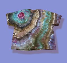 a t - shirt that has been dyed with different colors and patterns on the front