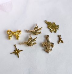 several different types of charms on a white surface