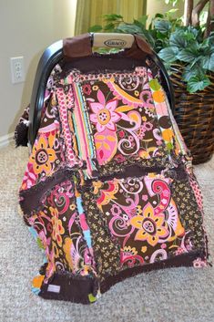 a baby stroller covered in colorful fabric